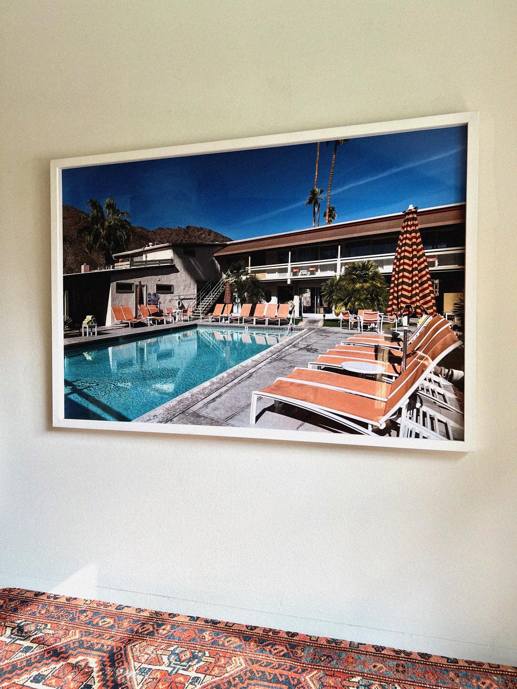 Photograph of the California Springs Hotel pool in Palm Springs with orange lounge chairs