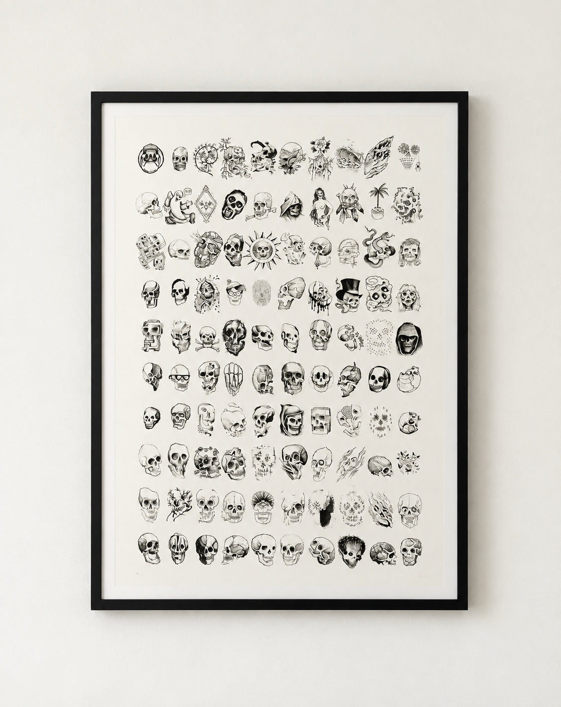 100 Skulls silkscreen print by Nathan Kostechko, framed in black on a white wall