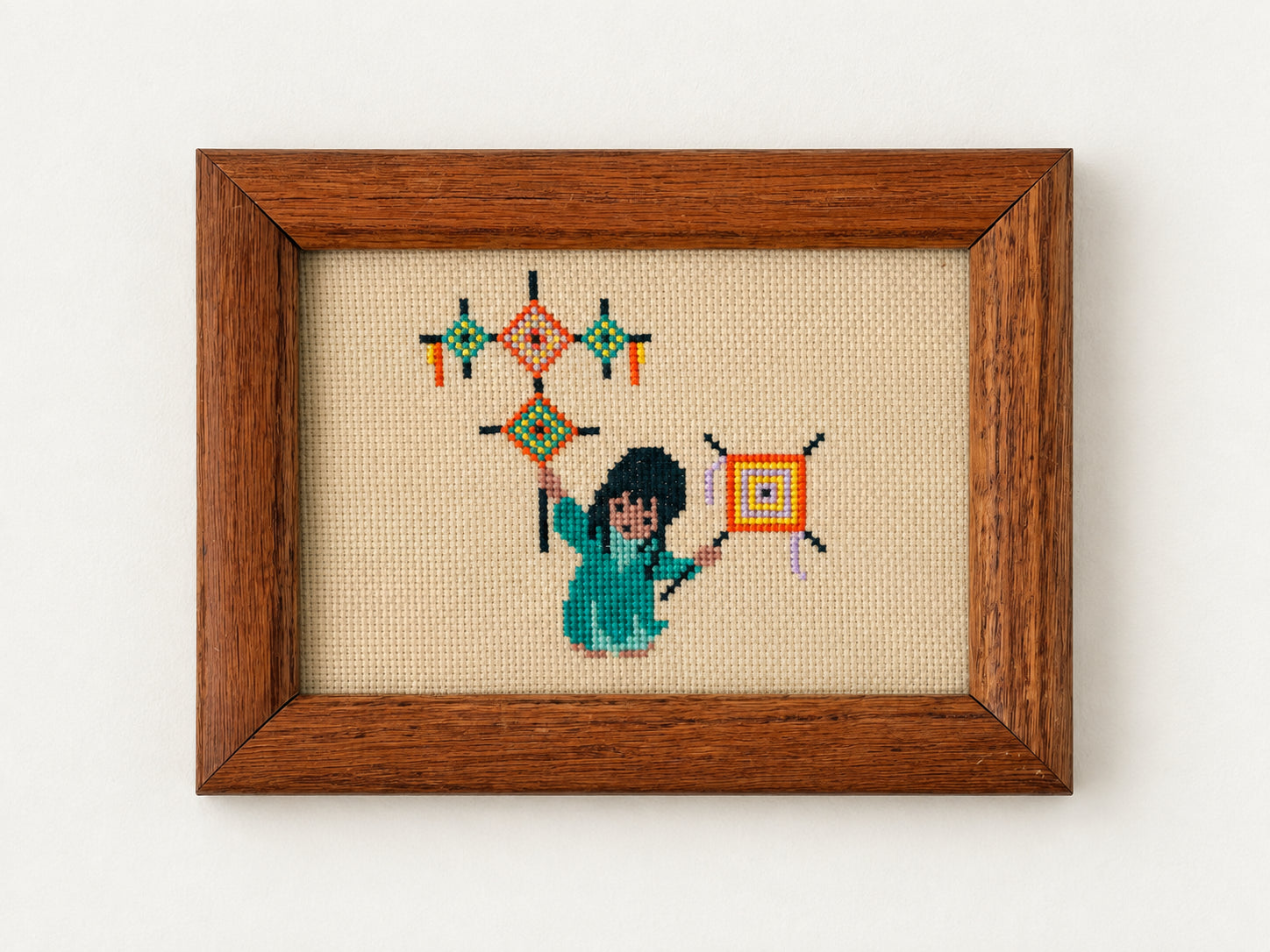 Vintage needlepoint of a figure flying colorful diamond kites, in an oak frame