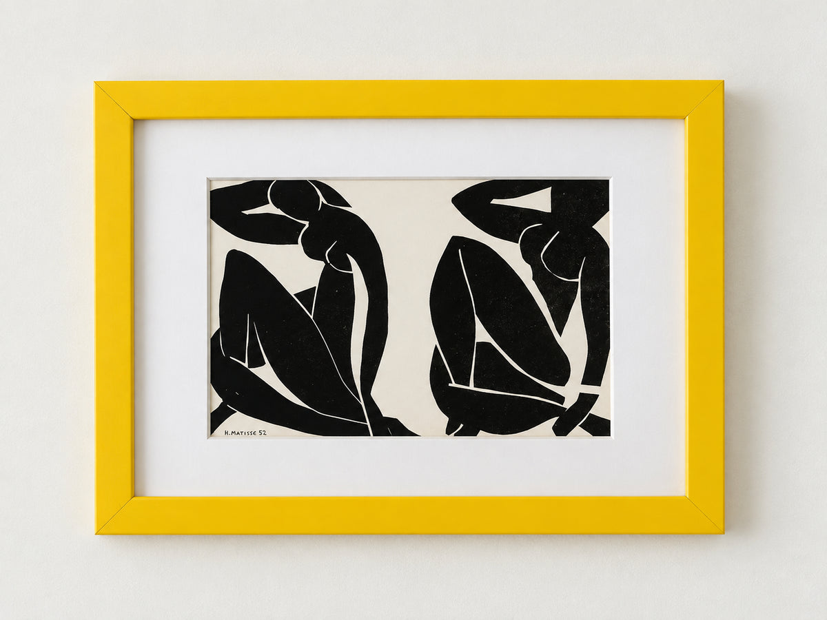 Black and white Matisse cut-out of two seated figures, matted in a yellow frame