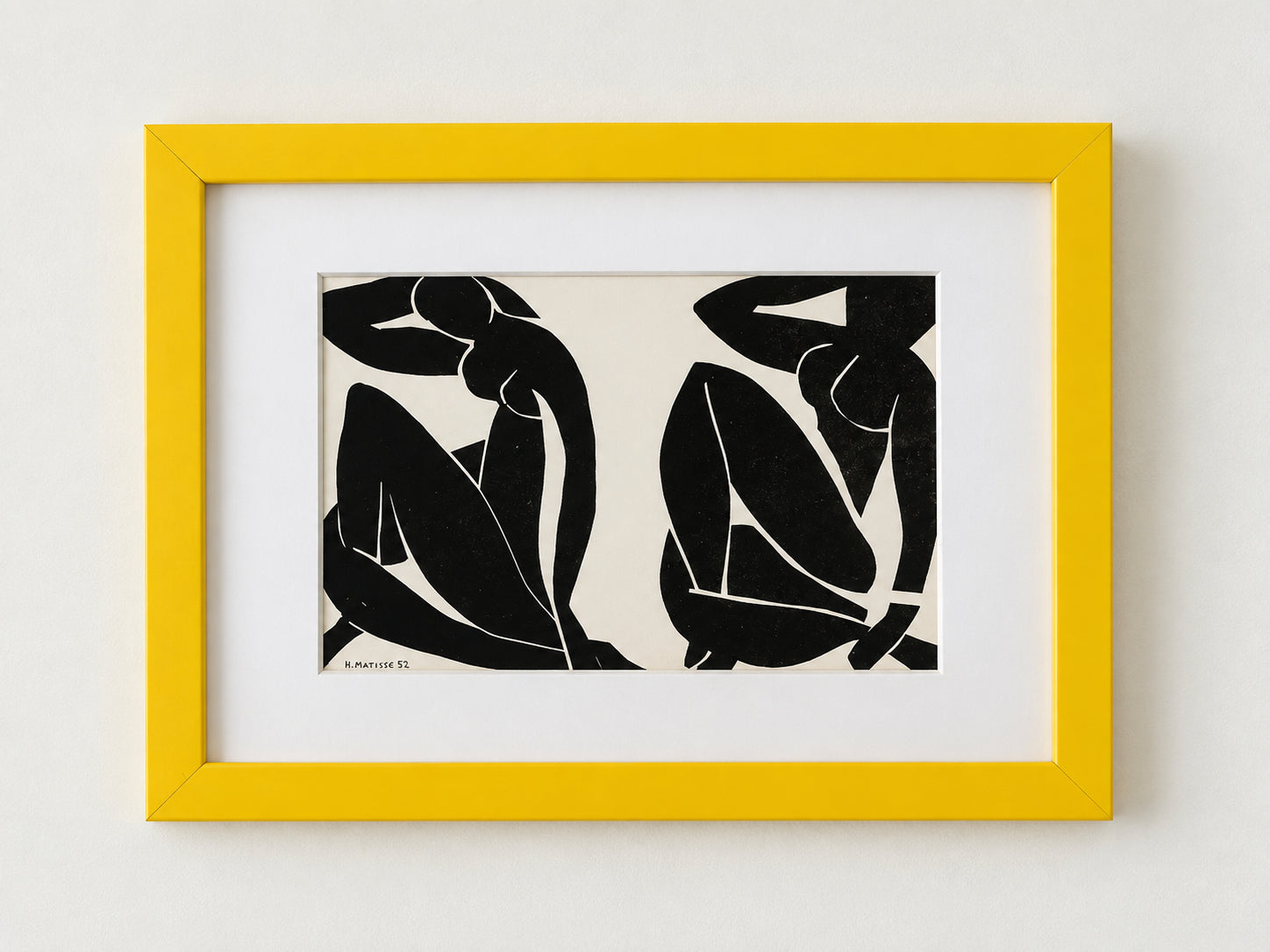 Black and white Matisse cut-out of two seated figures, matted in a yellow frame