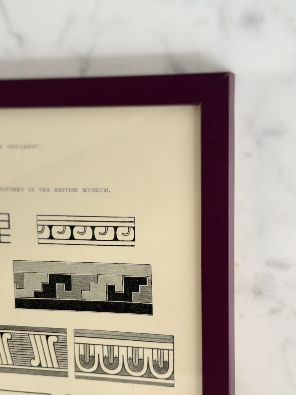 Framed print with geometric patterns on a marble surface
