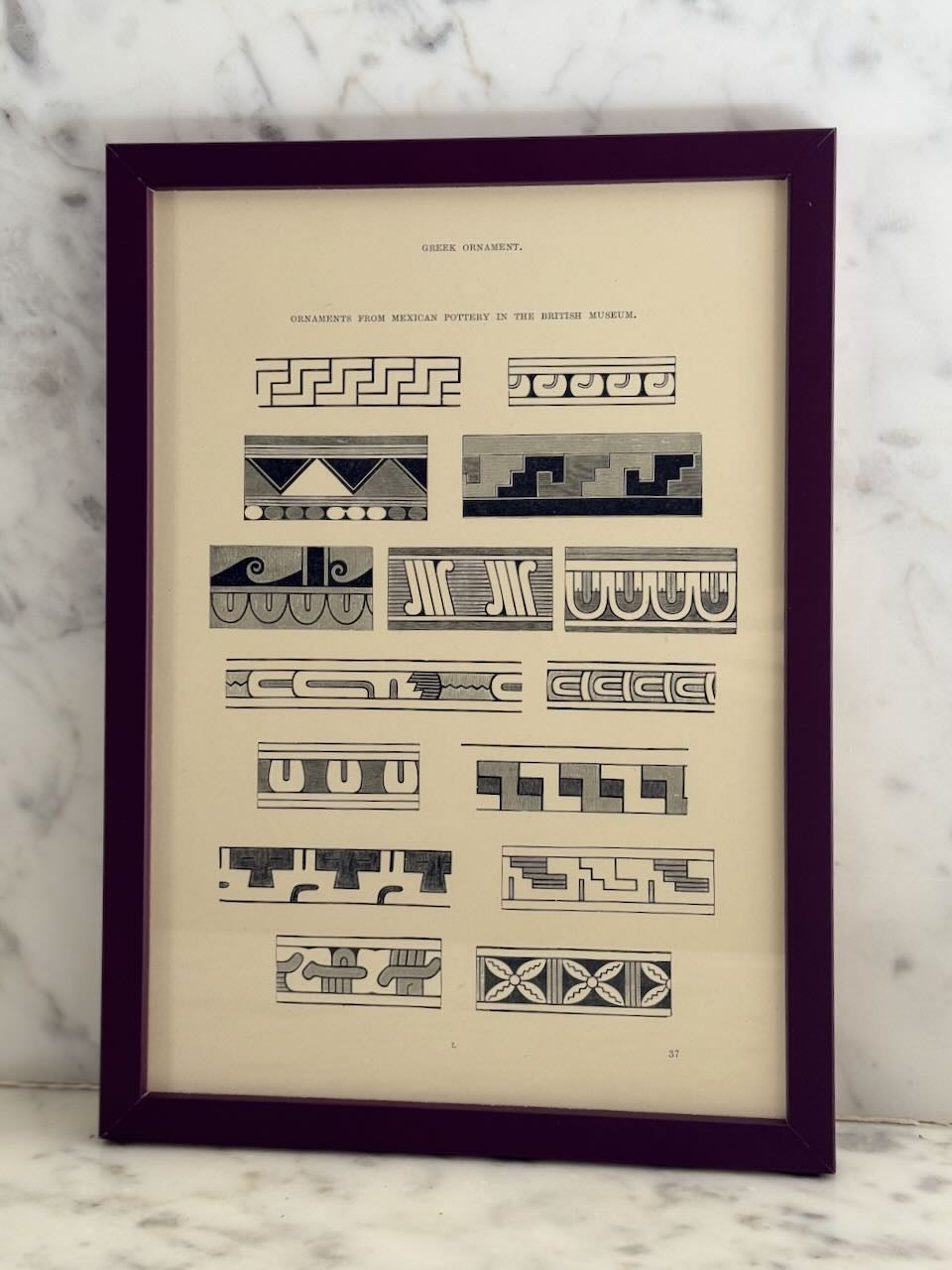 Framed print with geometric patterns on a marble surface